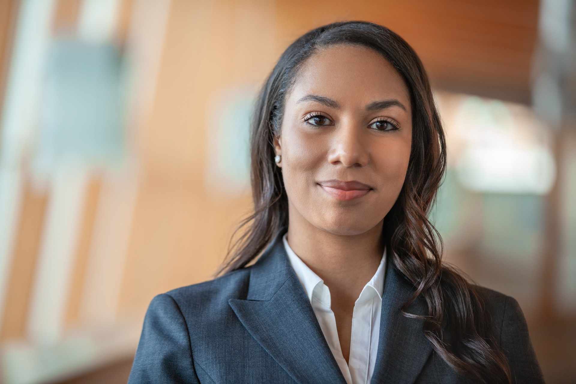 Portrait of multiracial African American Black young businesswoman standing in office lobby